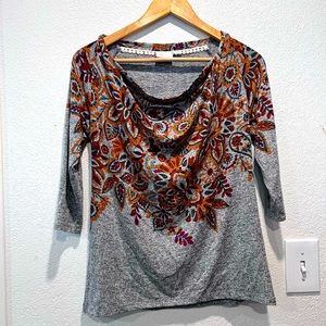 top with a swag front line.  3/4 sleeves. autumn floral print on front.